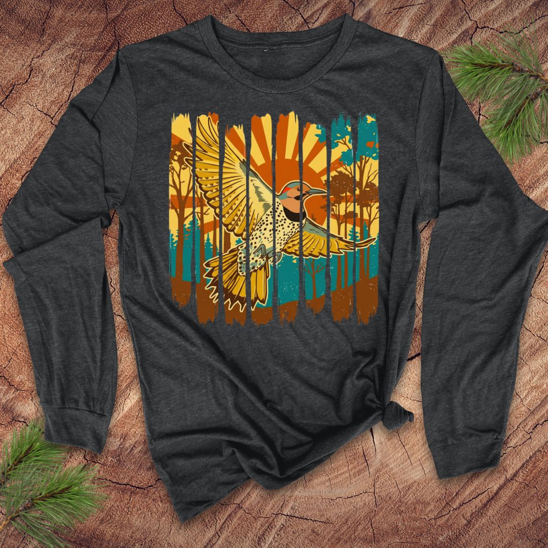 Gray long-sleeve shirt with a colorful northern flicker bird and sunrise design on a wooden surface