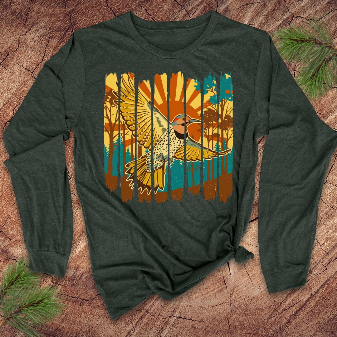 Green long-sleeve shirt with a colorful northern flicker bird and sunrise design on a wooden surface