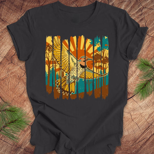 Gray t-shirt with a colorful graphic of a northern flicker and nature elements on a wooden surface.