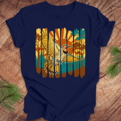 Navy blue t-shirt with a colorful graphic of a northern flicker and nature elements on a wooden surface.