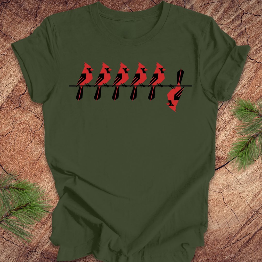 Green t-shirt with red cardinal design on a wooden surface