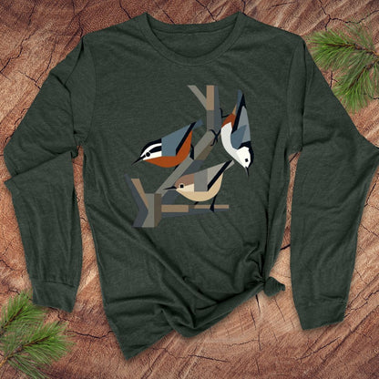 Green long-sleeve shirt with nuthatch bird design on a wooden surface