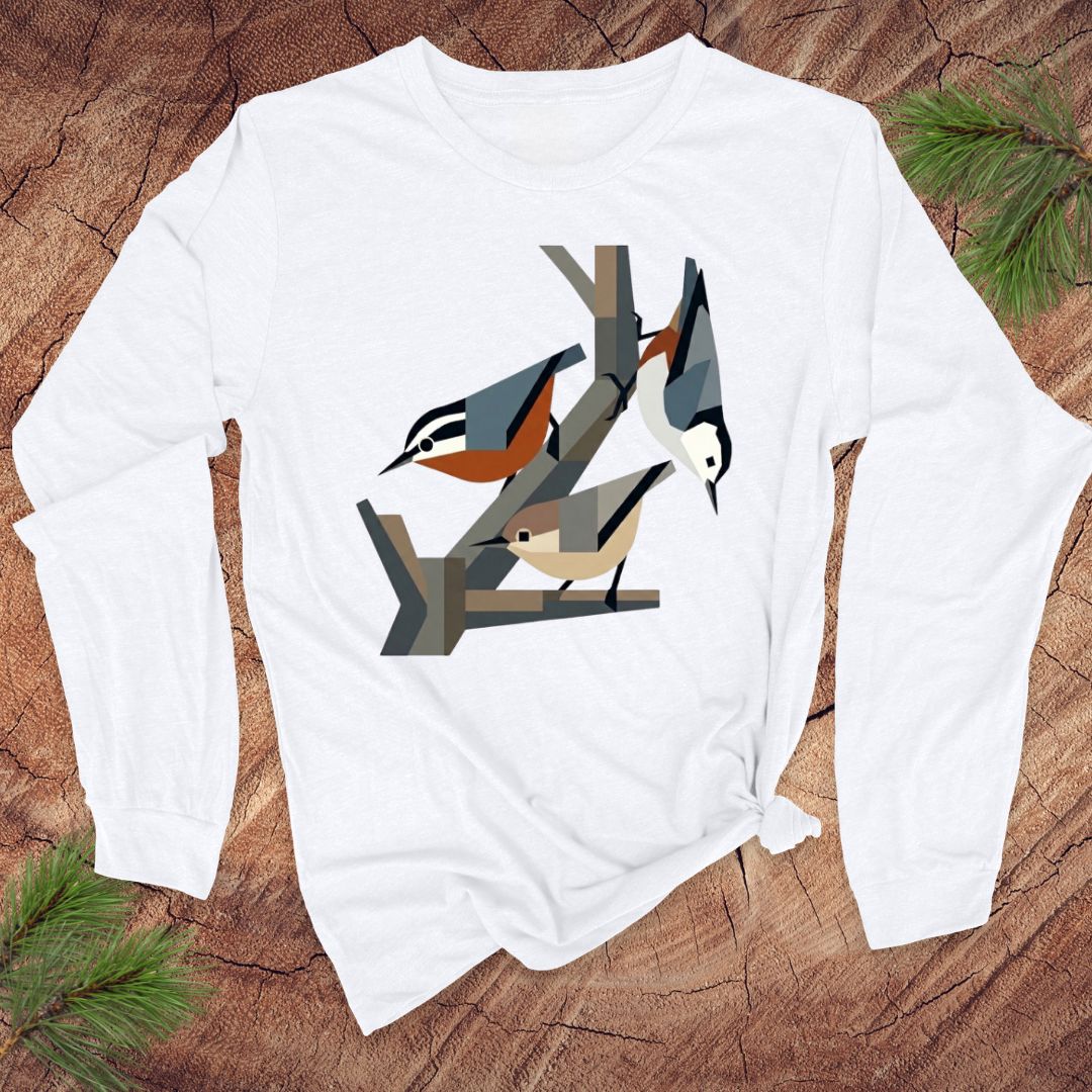 White long-sleeve shirt with nuthatch bird design on a wooden surface