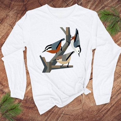 White long-sleeve shirt with nuthatch bird design on a wooden surface