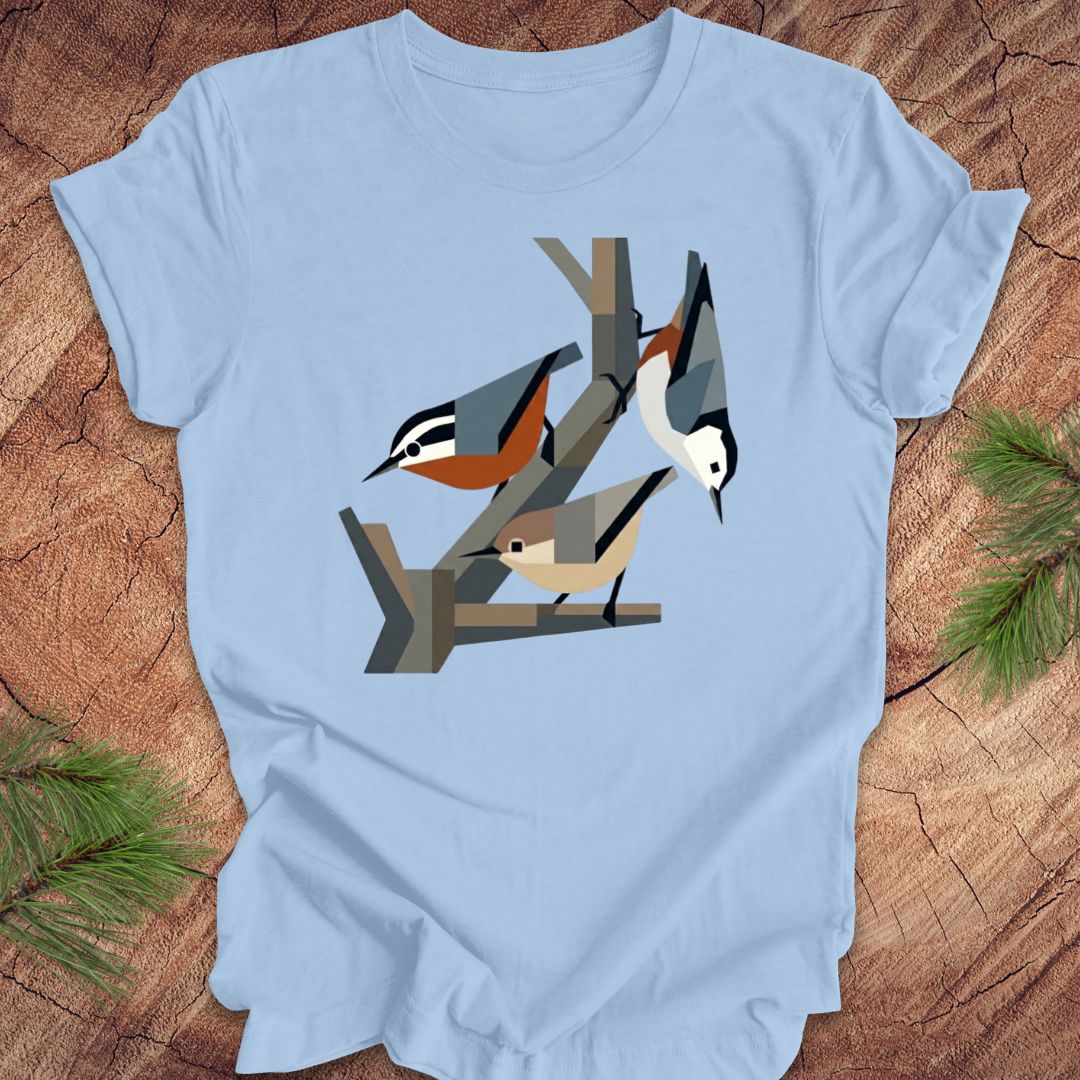 Light blue t-shirt with nuthatch design on a wooden surface