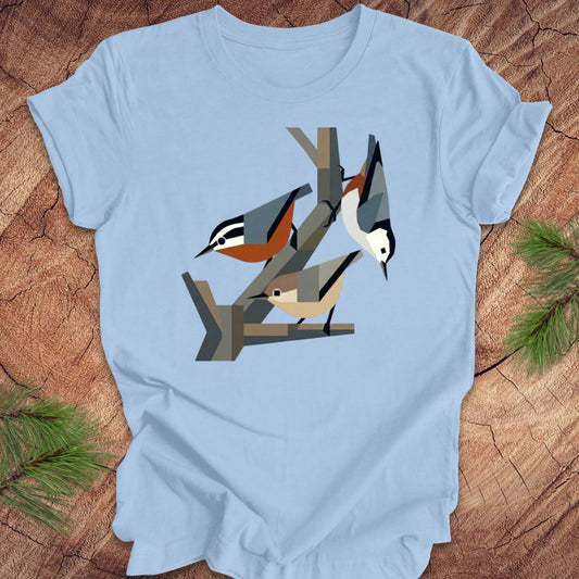 Light blue t-shirt with nuthatch design on a wooden surface