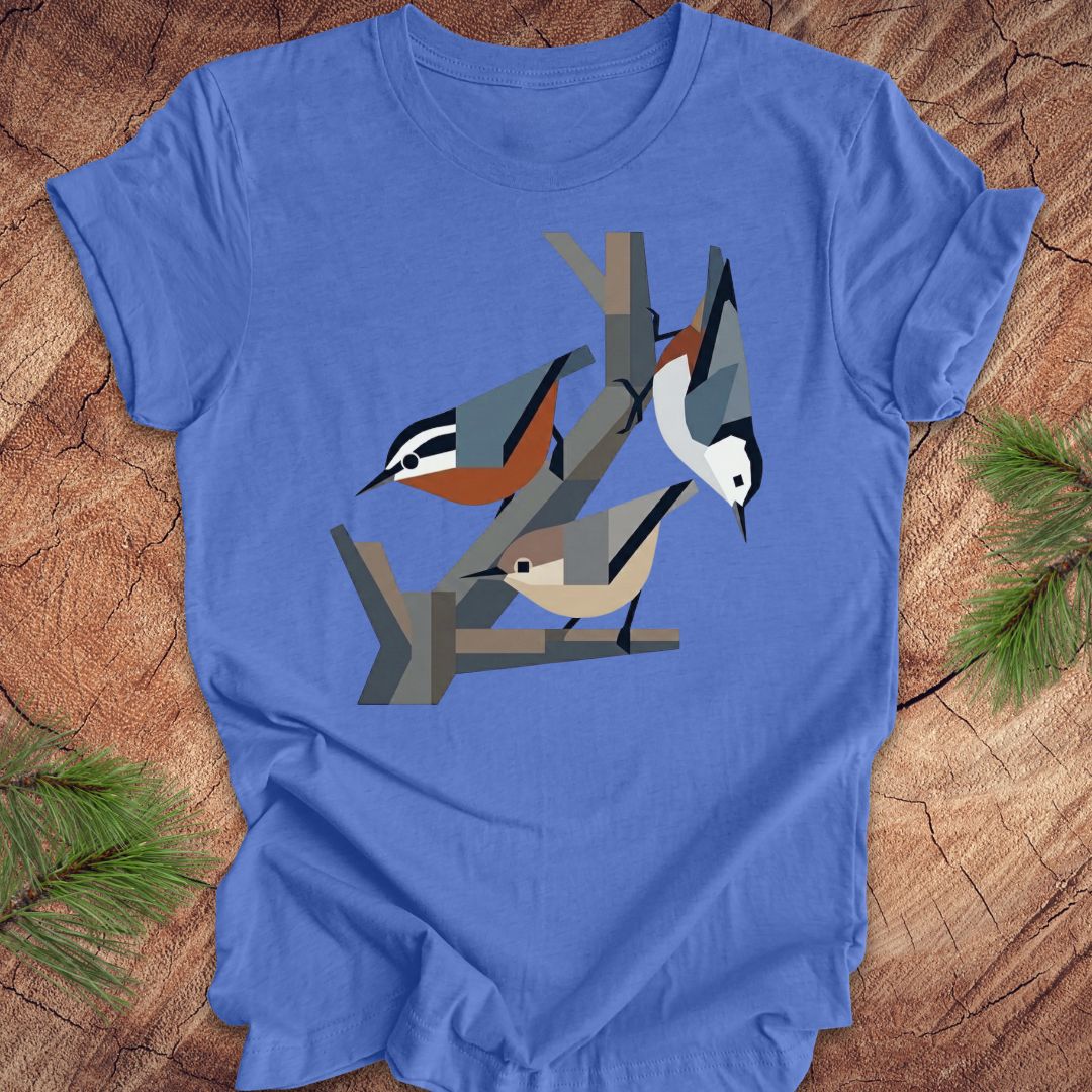 Blue t-shirt with nuthatch design on a wooden surface