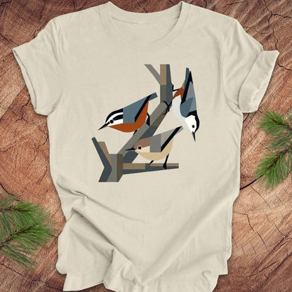 Beige t-shirt with nuthatch design on a wooden surface