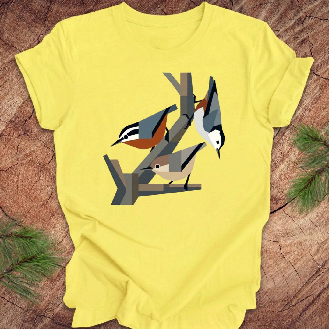 Yellow t-shirt with nuthatch design on a wooden surface