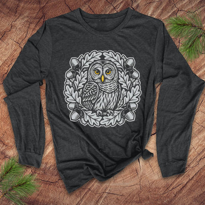 Dark gray long sleeve tshirt with an oak tree and owl design on a wooden surface