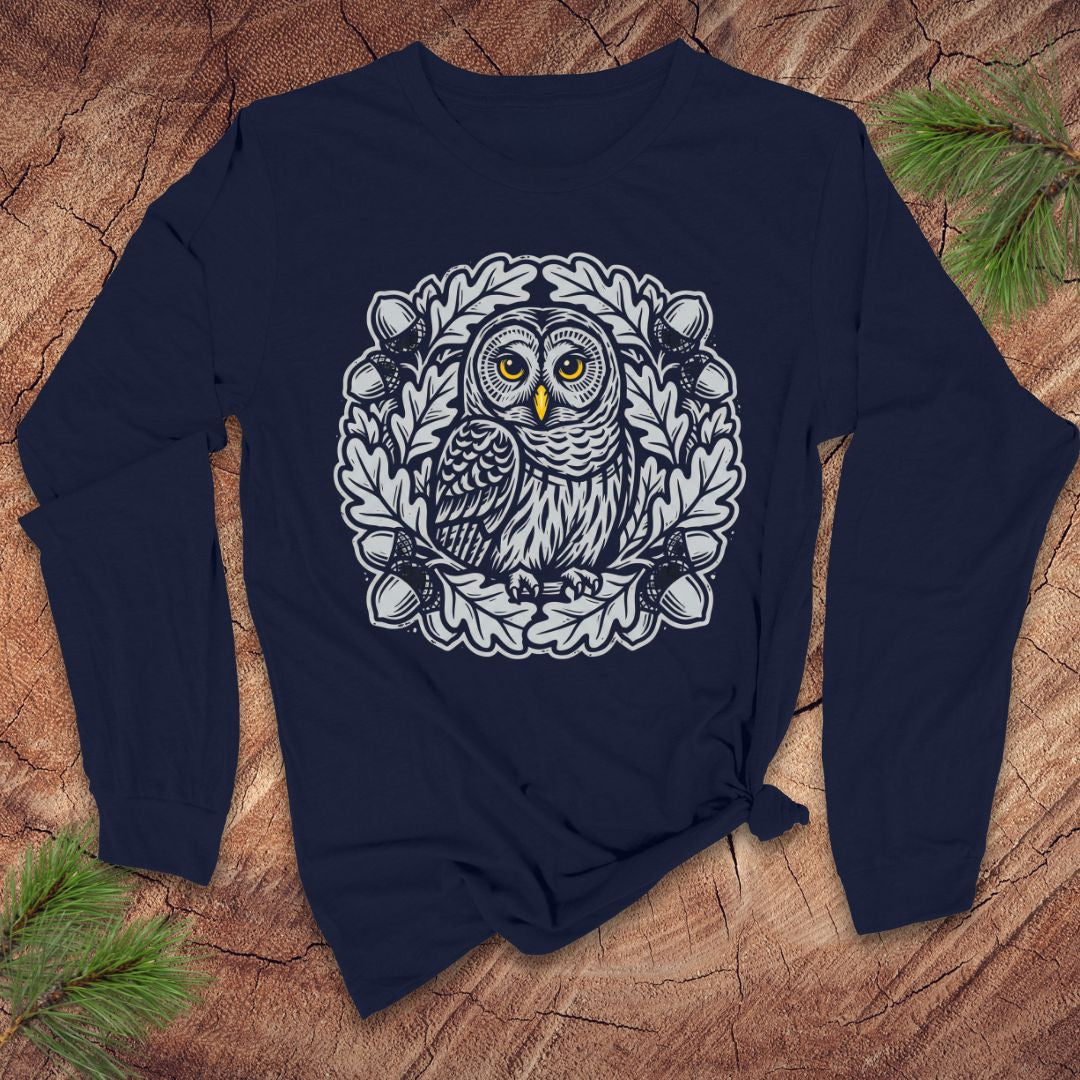 Navy blue long sleeve tshirt with an oak tree and owl design on a wooden surface