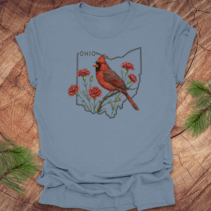 Steel blue t-shirt with a cardinal and floral design on an Ohio map, placed on a wooden surface.