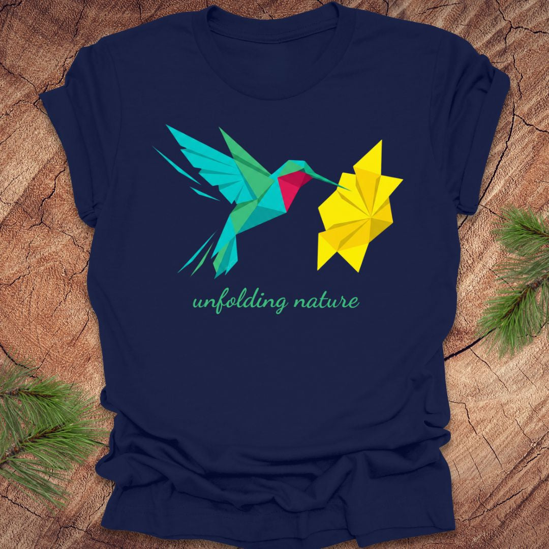 Navy blue t-shirt with a colorful hummingbird and flower design on a wooden surface.