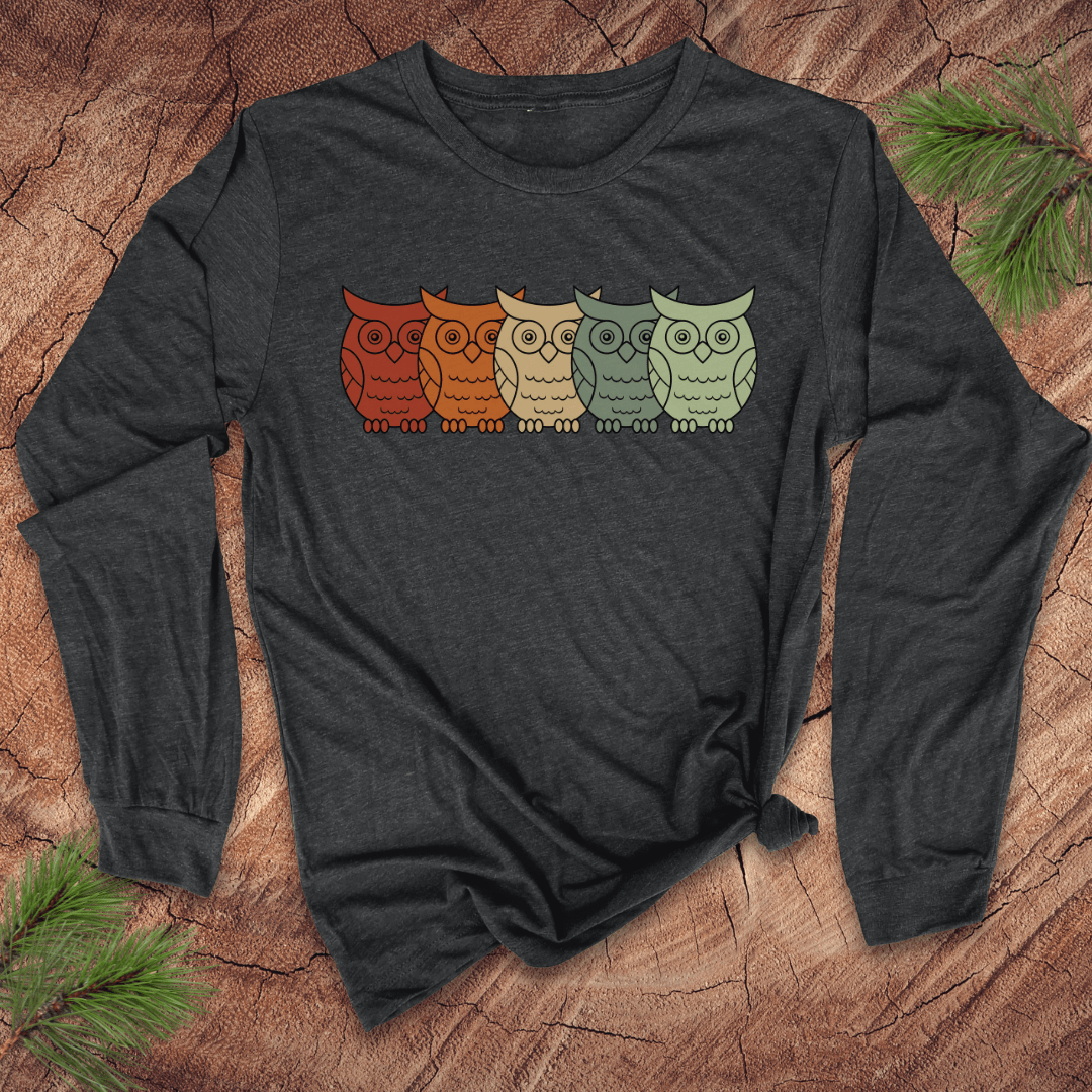 Dark gray long-sleeve shirt with colorful owl design on a wooden surface