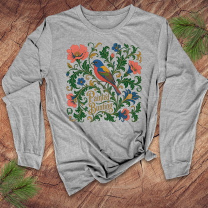 Gray long-sleeve shirt with colorful bird and floral design on a wooden surface