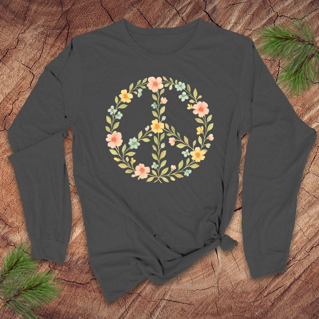 Light gray long-sleeve shirt with a floral peace symbol design on a wooden surface.