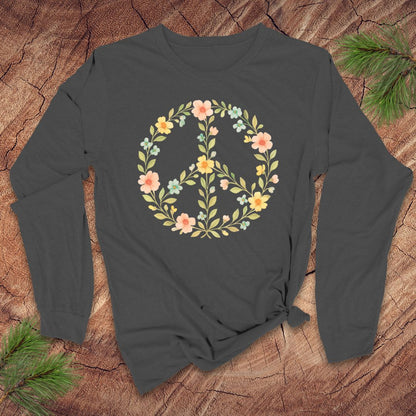 Light gray long-sleeve shirt with a floral peace symbol design on a wooden surface.