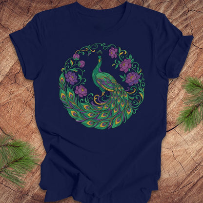 Navy blue t-shirt with a peacock and flowers design on a wooden surface