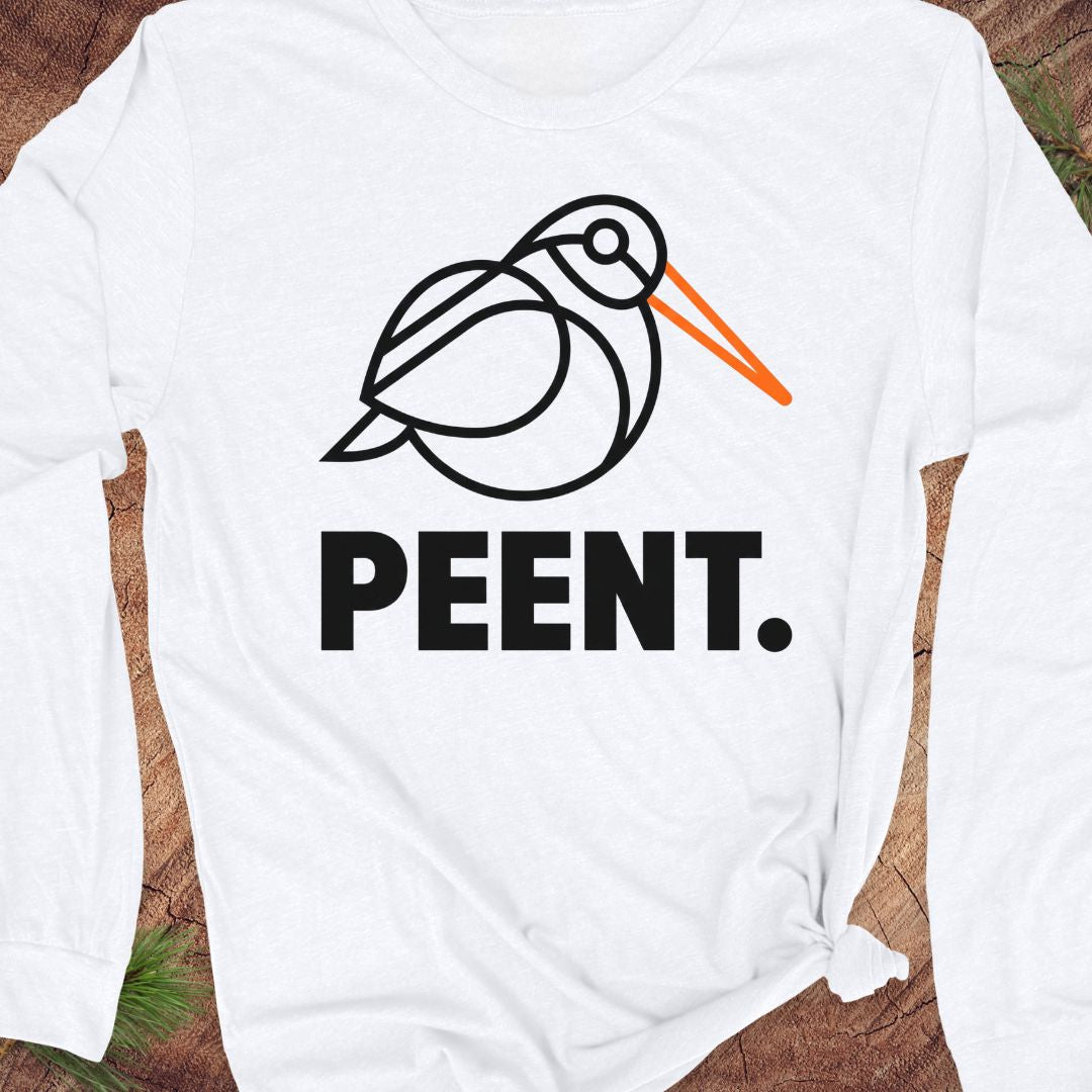 White long-sleeve shirt with 'PEENT.' woodcock design on a wooden surface