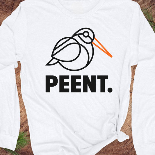 White long-sleeve shirt with 'PEENT.' woodcock design on a wooden surface