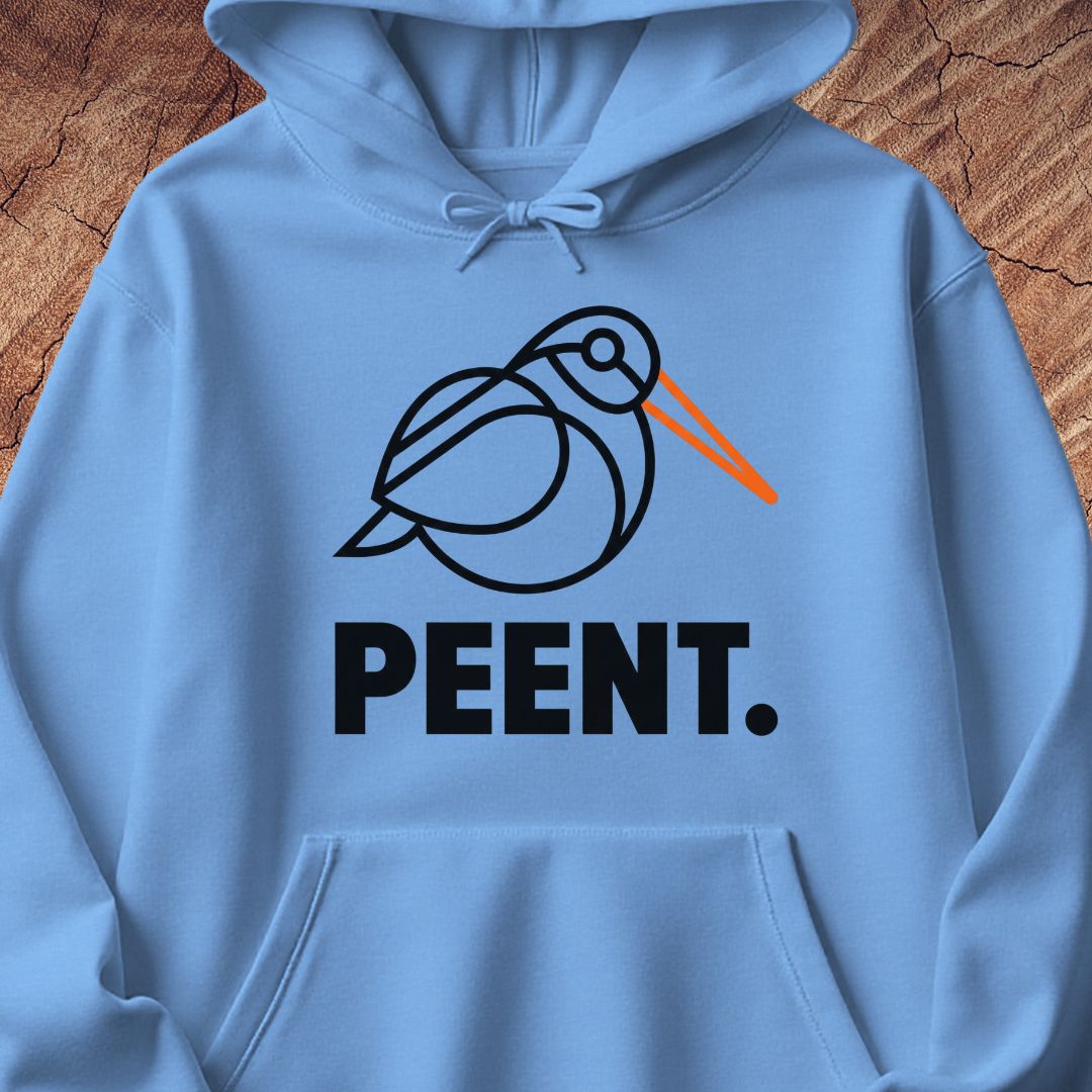 A light blue hoodie laid flat on a rustic wood background, featuring a black line-art bird graphic with an orange beak and the word 'PEENT.' in bold black letters below.