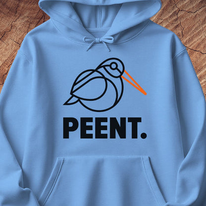 A light blue hoodie laid flat on a rustic wood background, featuring a black line-art bird graphic with an orange beak and the word 'PEENT.' in bold black letters below.