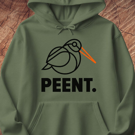 An olive green pullover hoodie featuring a black line art graphic of a bird with an orange beak and the word 'PEENT.' printed below in bold black letters, displayed against a textured brown wood background.