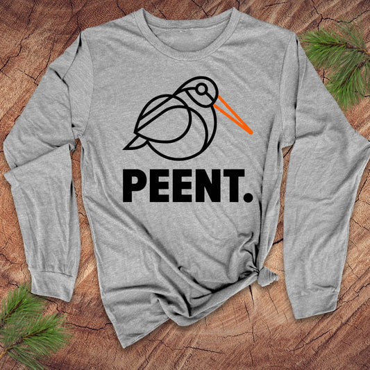 Gray long-sleeve shirt with 'PEENT.' woodcock design on a wooden surface