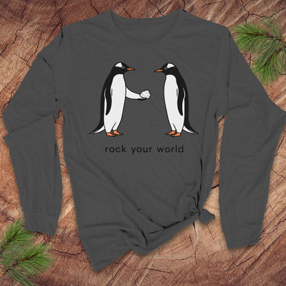 Gray long-sleeve t-shirt with penguins and text 'rock your world' on a wood background.