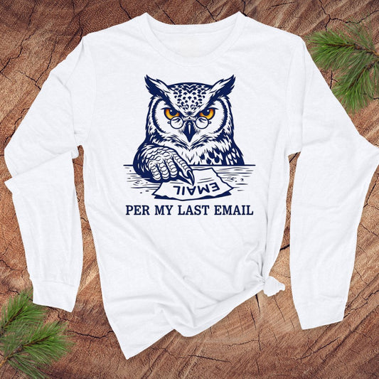 White long-sleeve shirt with an owl graphic and text, 'per my last email' on a wooden surface