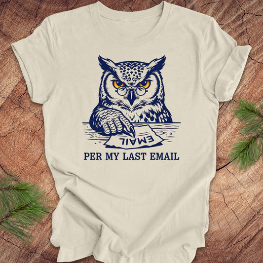 Beige t-shirt with an owl graphic and text, 'per my last email' on a wooden surface