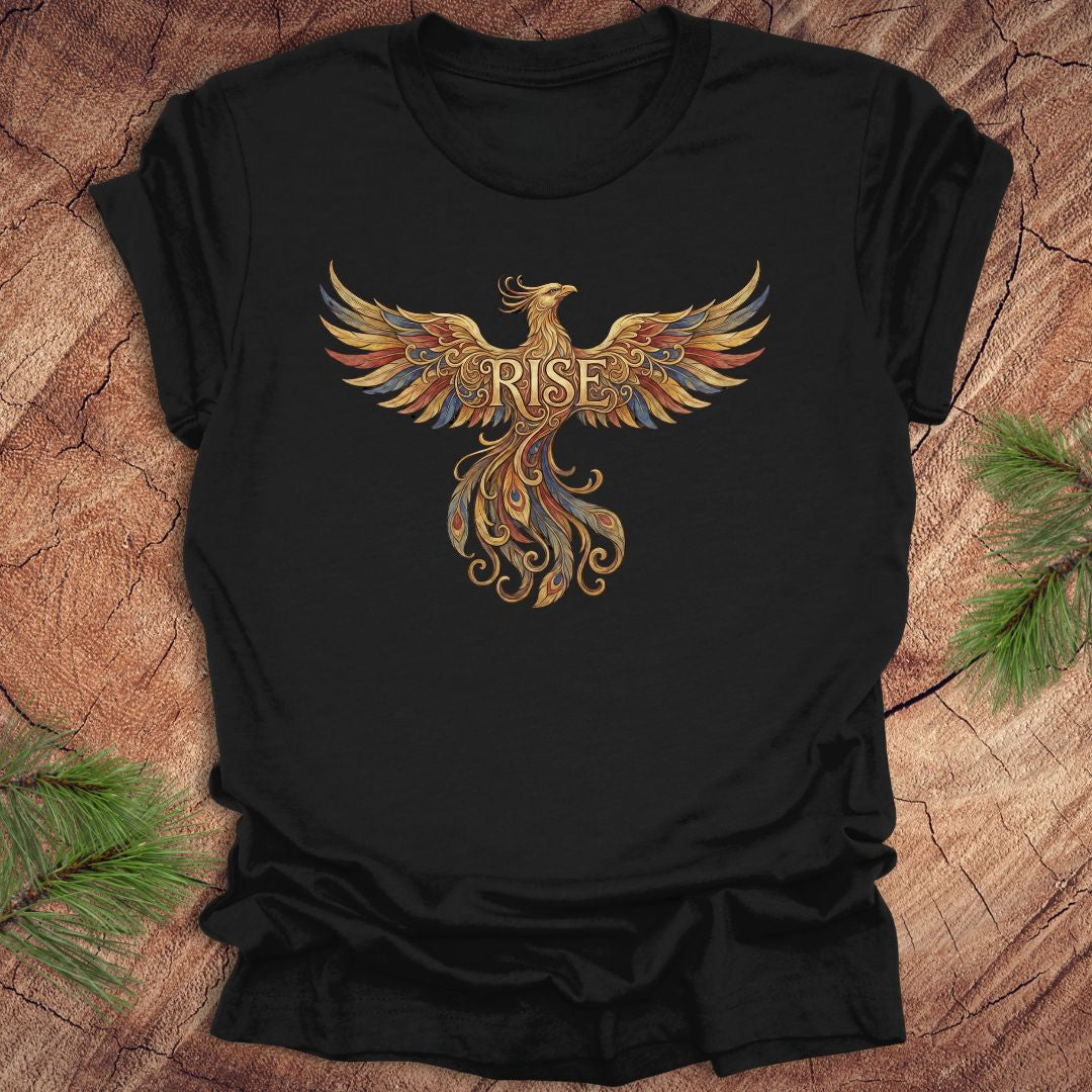 Black t-shirt with a colorful phoenix design and 'RISE' text on a wooden surface.