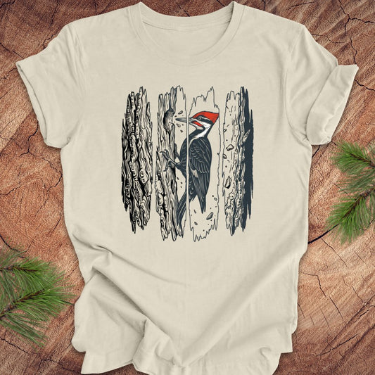 Beige t-shirt with a woodpecker design on a wooden surface