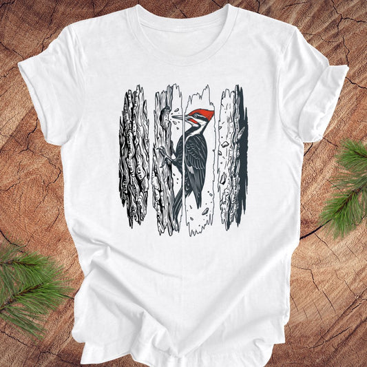 White t-shirt with a woodpecker design on a wooden surface