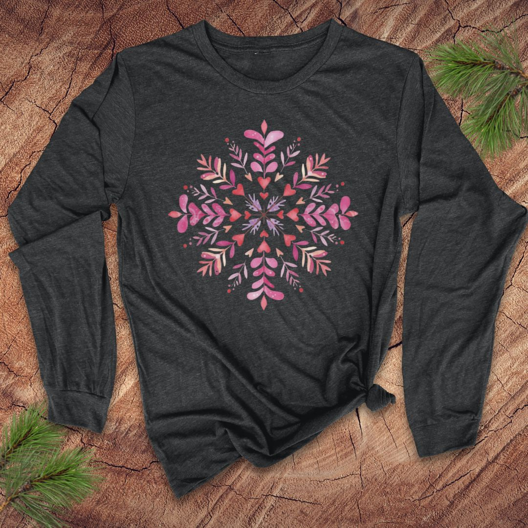 Dark grey long-sleeve shirt with pink hearts and floral snowflake design on a wooden surface