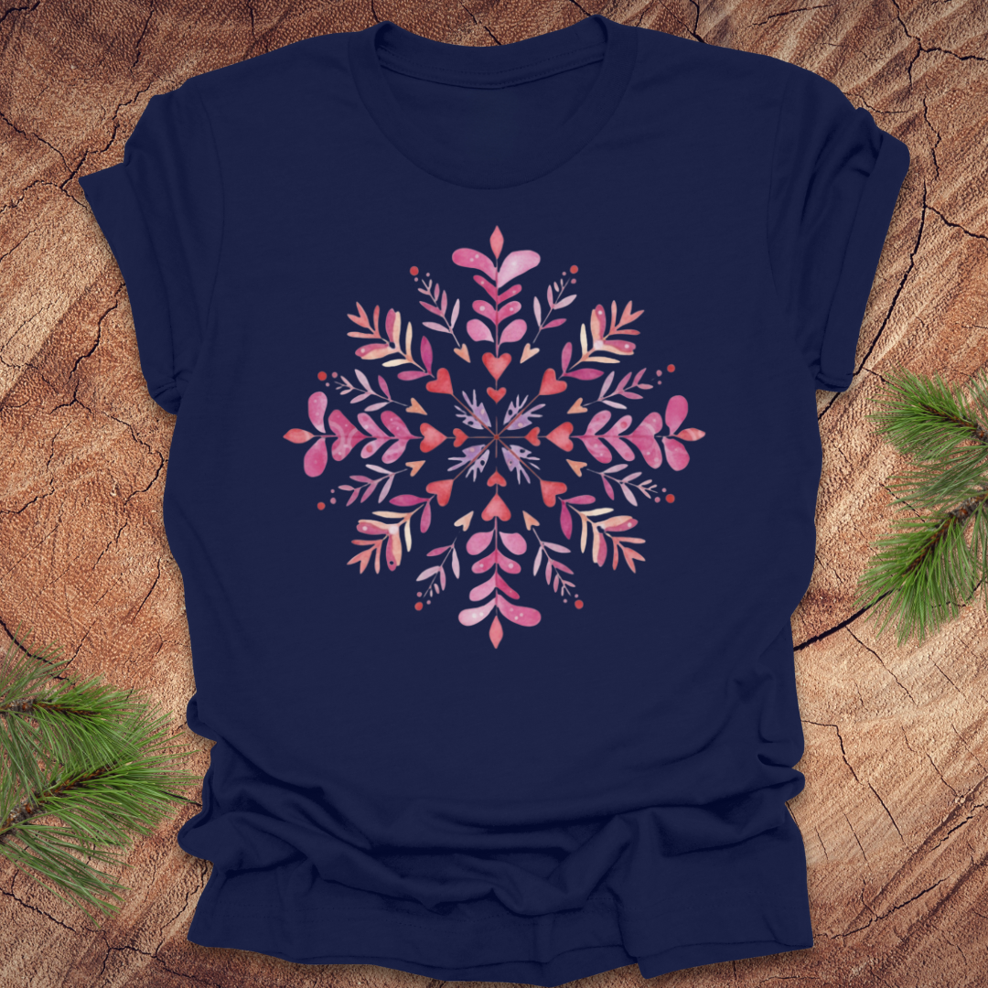 Navy blue t-shirt with pinkhearts and floral snowflake design on a wooden surface
