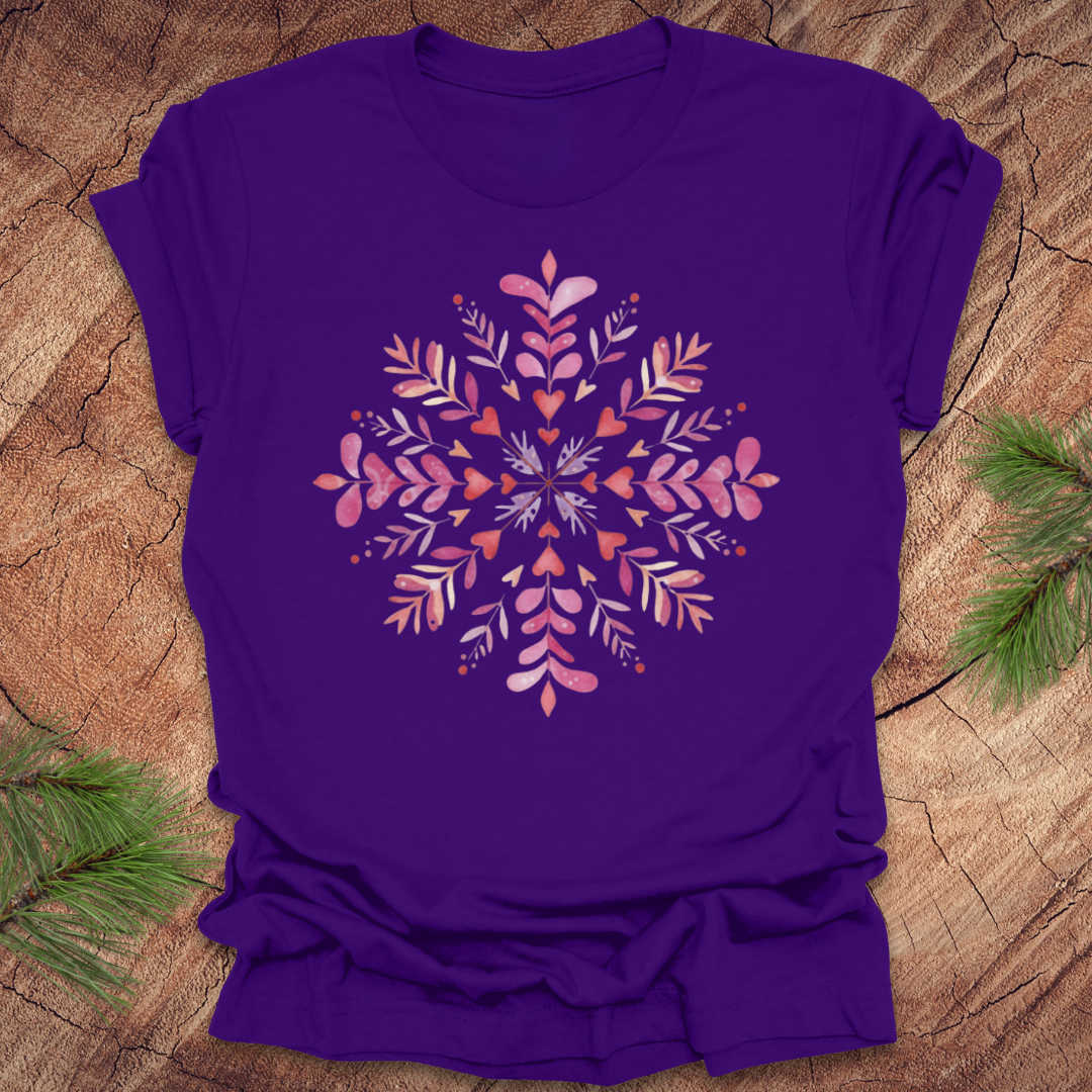 Purple t-shirt with pinkhearts and floral snowflake design on a wooden surface