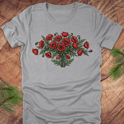Gray t-shirt with red poppy bouquet design on a wooden surface