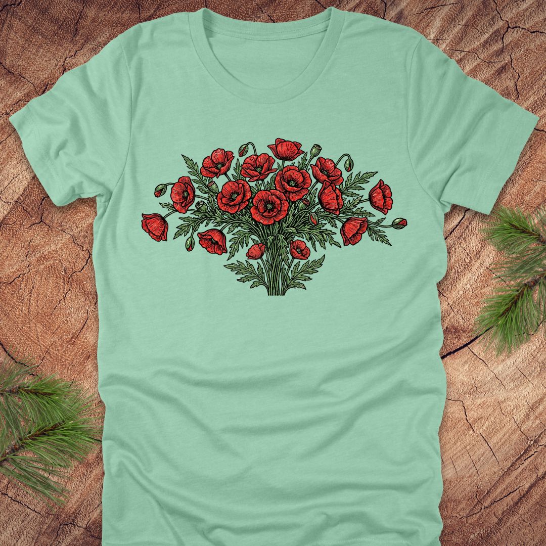 Mint green t-shirt with red poppy bouquet design on a wooden surface