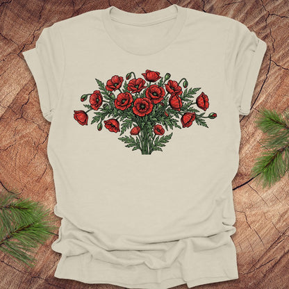 Beige t-shirt with red poppy bouquet design on a wooden surface