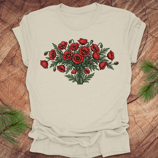 Beige t-shirt with red poppy bouquet design on a wooden surface