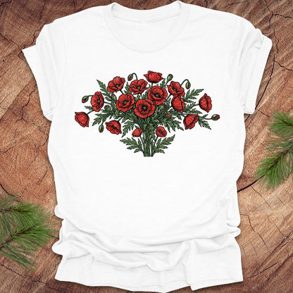 White t-shirt with red poppy bouquet design on a wooden surface