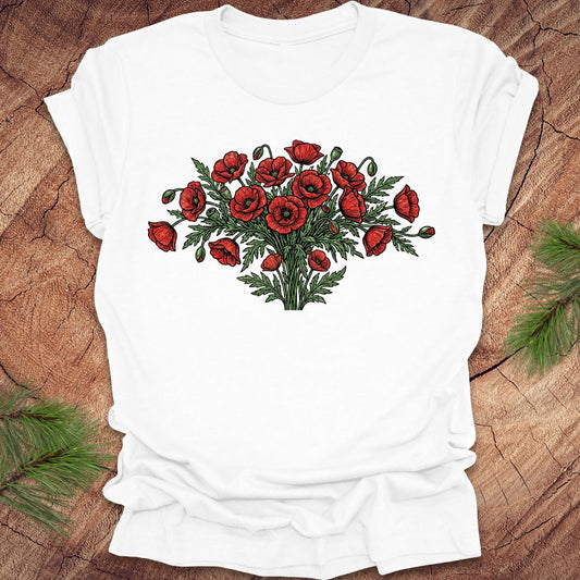 White t-shirt with red poppy bouquet design on a wooden surface
