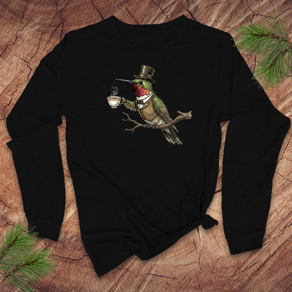 Black long-sleeve shirt with a vintage hummingbird with top hat and tea design on a wooden surface.
