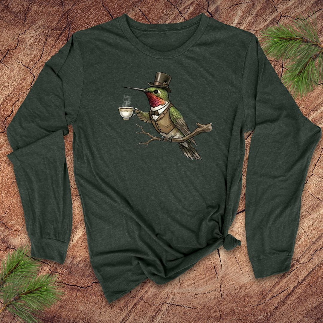 Forest green long-sleeve shirt with a vintage hummingbird with top hat and tea design on a wooden surface.