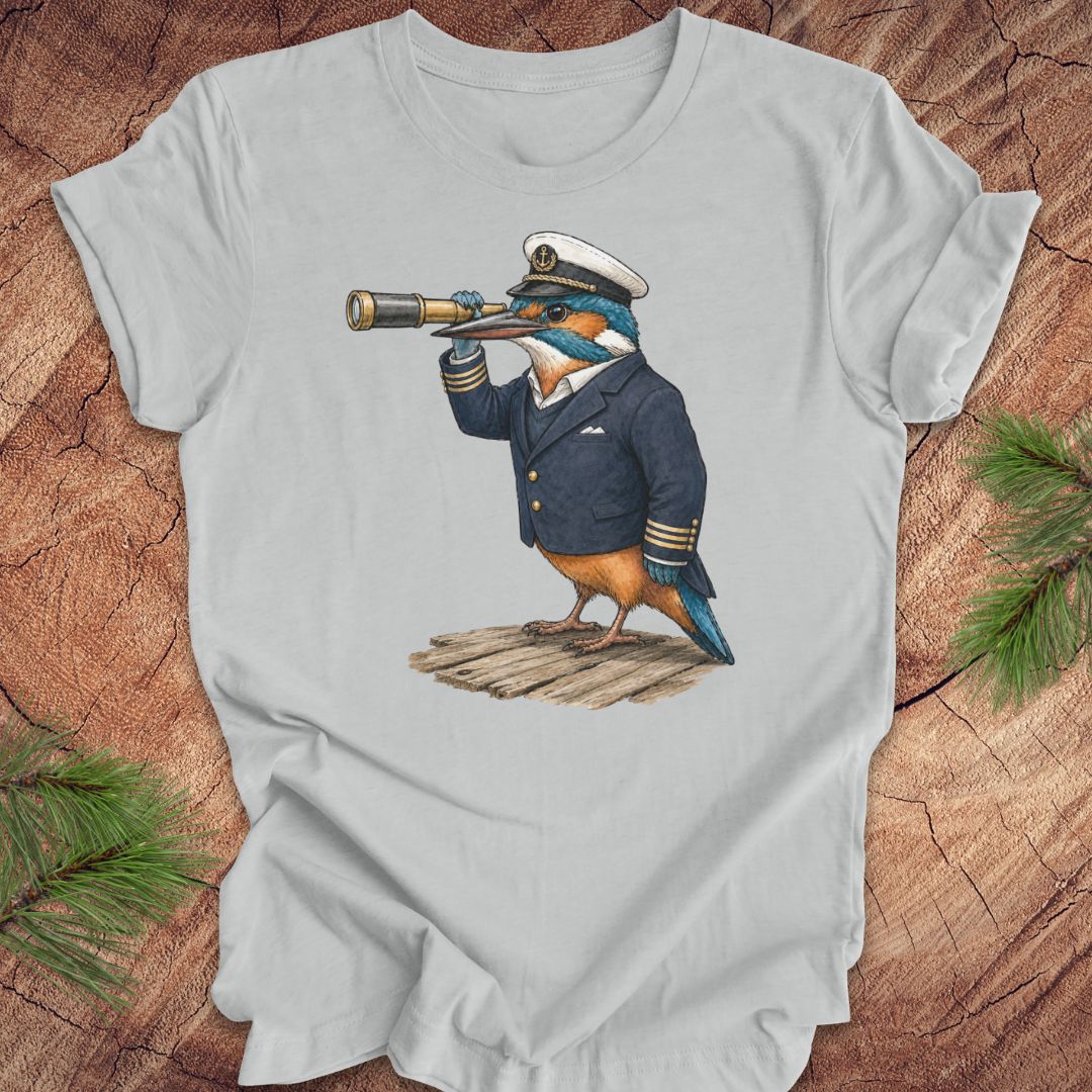 Gray t-shirt with a kingfisher bird in a captain's outfit and spyglass on a wooden surface.