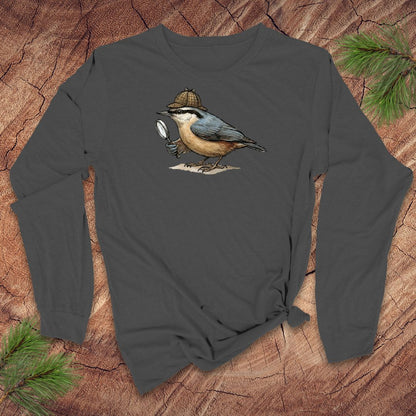 Grey long-sleeve shirt with a nuthatch bird with a Sherlock Holmes hat and magnifying glass graphic on a wooden surface