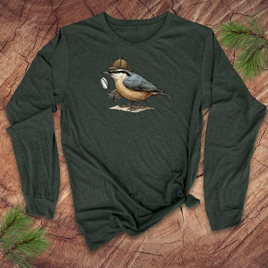 Green long-sleeve shirt with a nuthatch bird with a Sherlock Holmes hat and magnifying glass graphic on a wooden surface