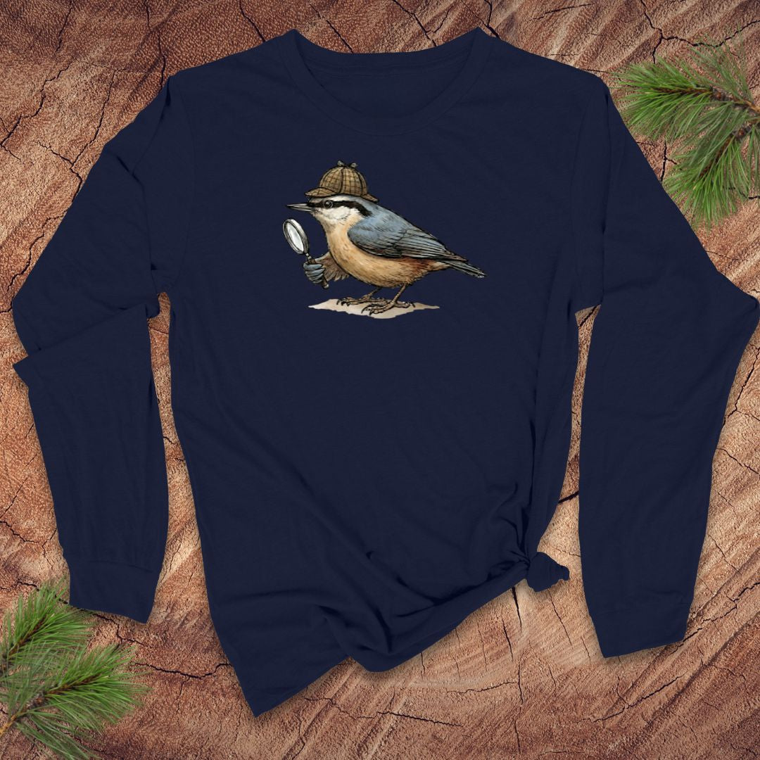 Navy blue long-sleeve shirt with a nuthatch bird with a Sherlock Holmes hat and magnifying glass graphic on a wooden surface