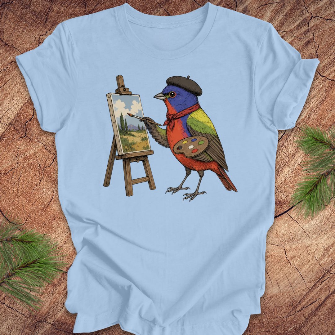 Light blue t-shirt with a painted bunting bird painting on a wooden surface
